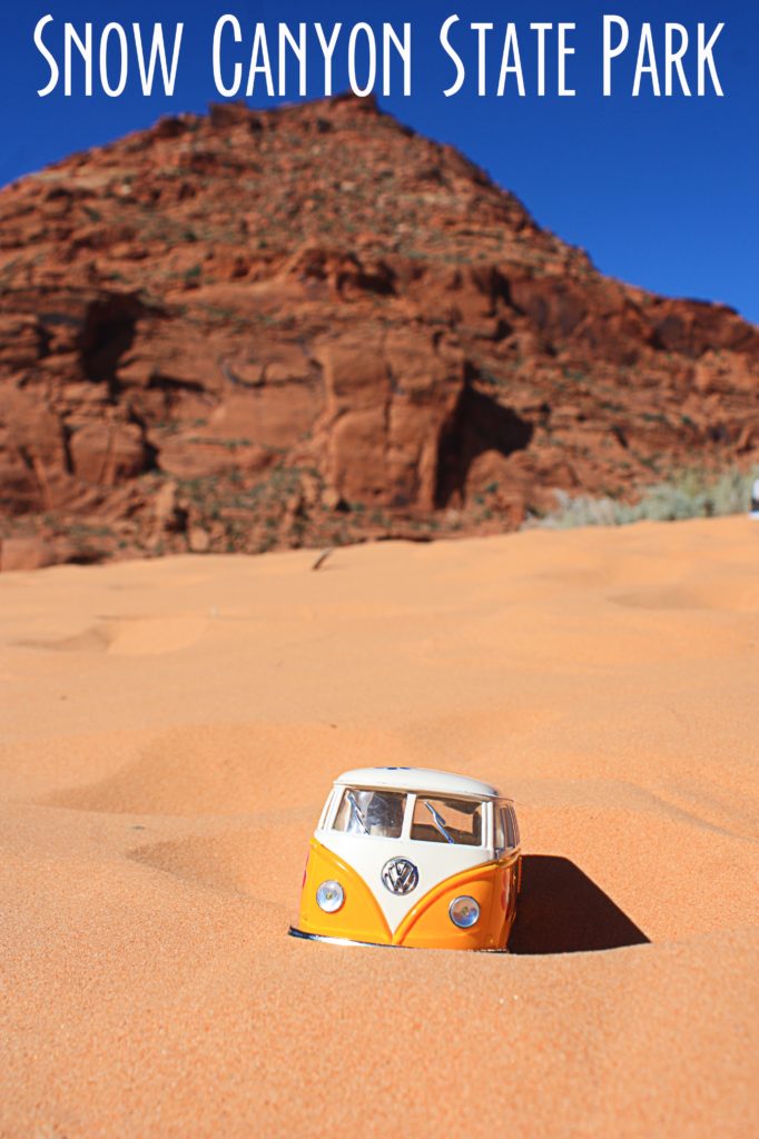 Yellow van in the sand at Snow Canyon with red rock mountain