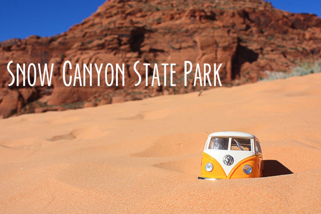 Yellow van in the sand at Snow Canyon with red rock mountain