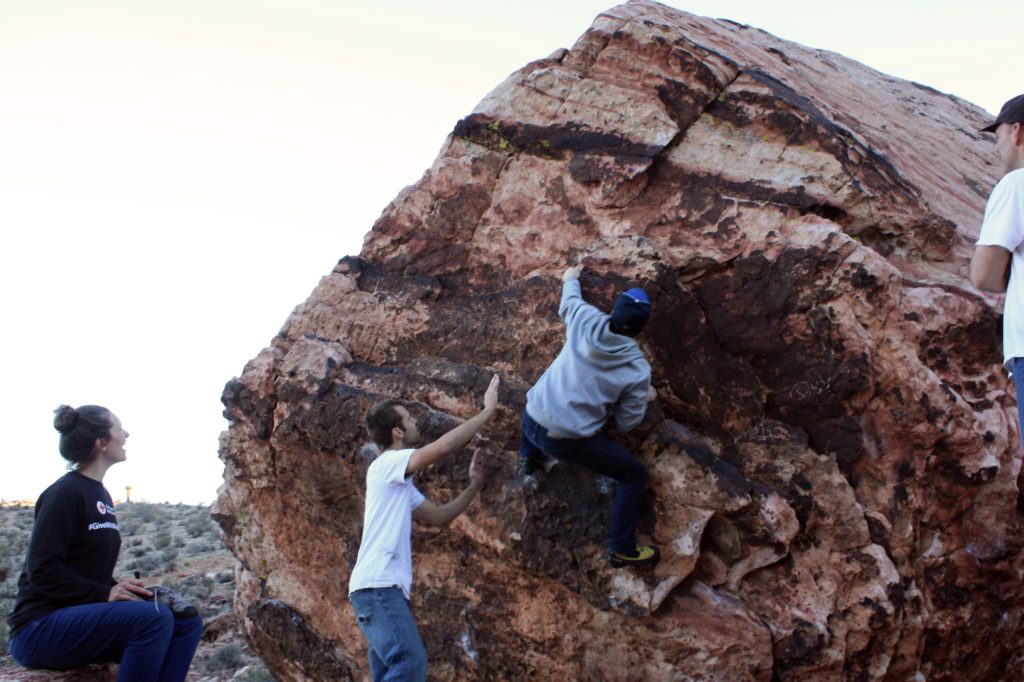 boy climber in a slight overhang with spotter below