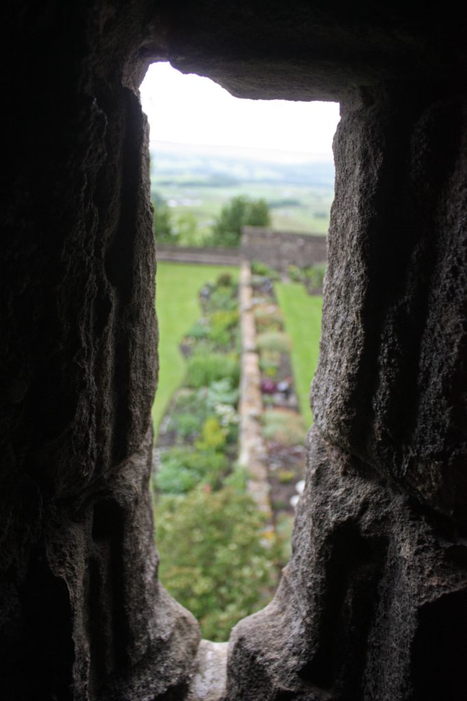 a view from an arrow slit showing a garden at Stirling Castle