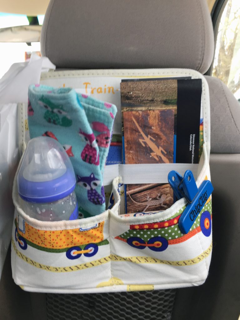 the car organizer full of items on a trip