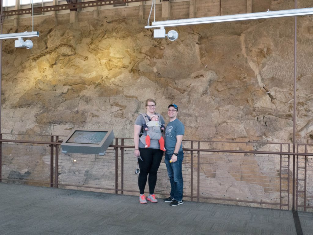 The yellow van family standing in front of the quarry fossil wall at Dinosaur National Monument