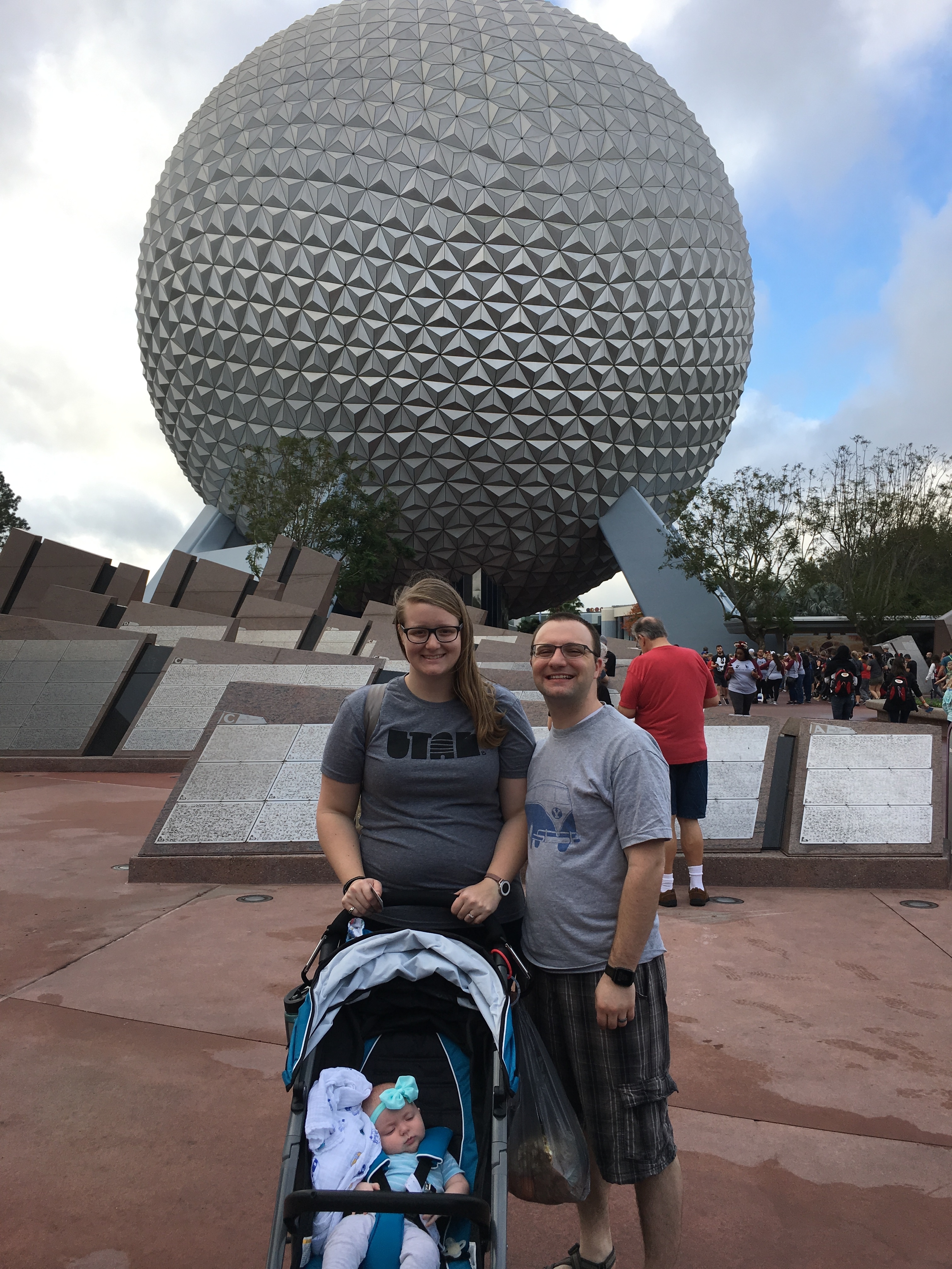 Ben, Meagan, and baby with Spaceship earth