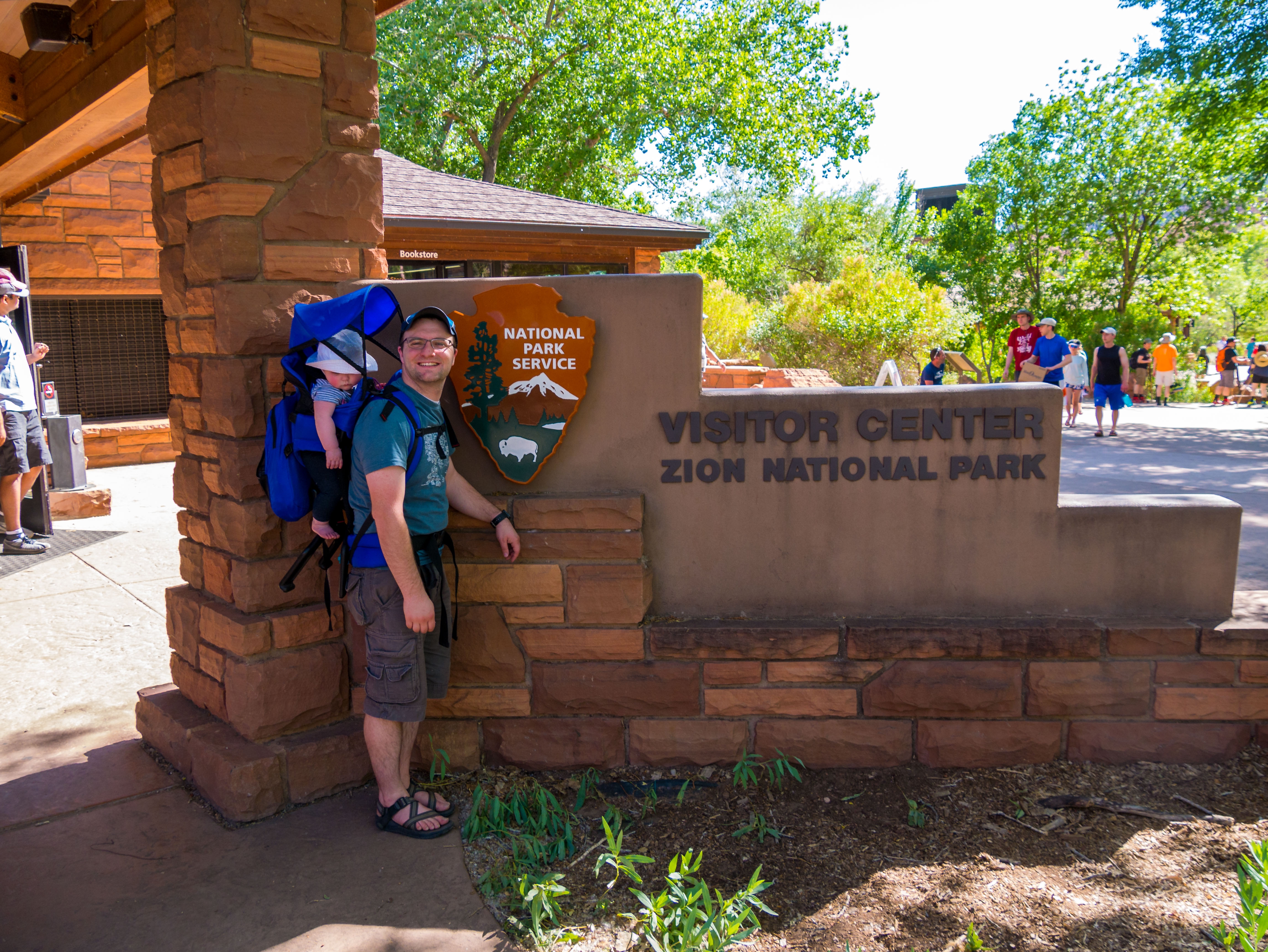 Ben and Lucy at the visitor center sign in Zion National Park