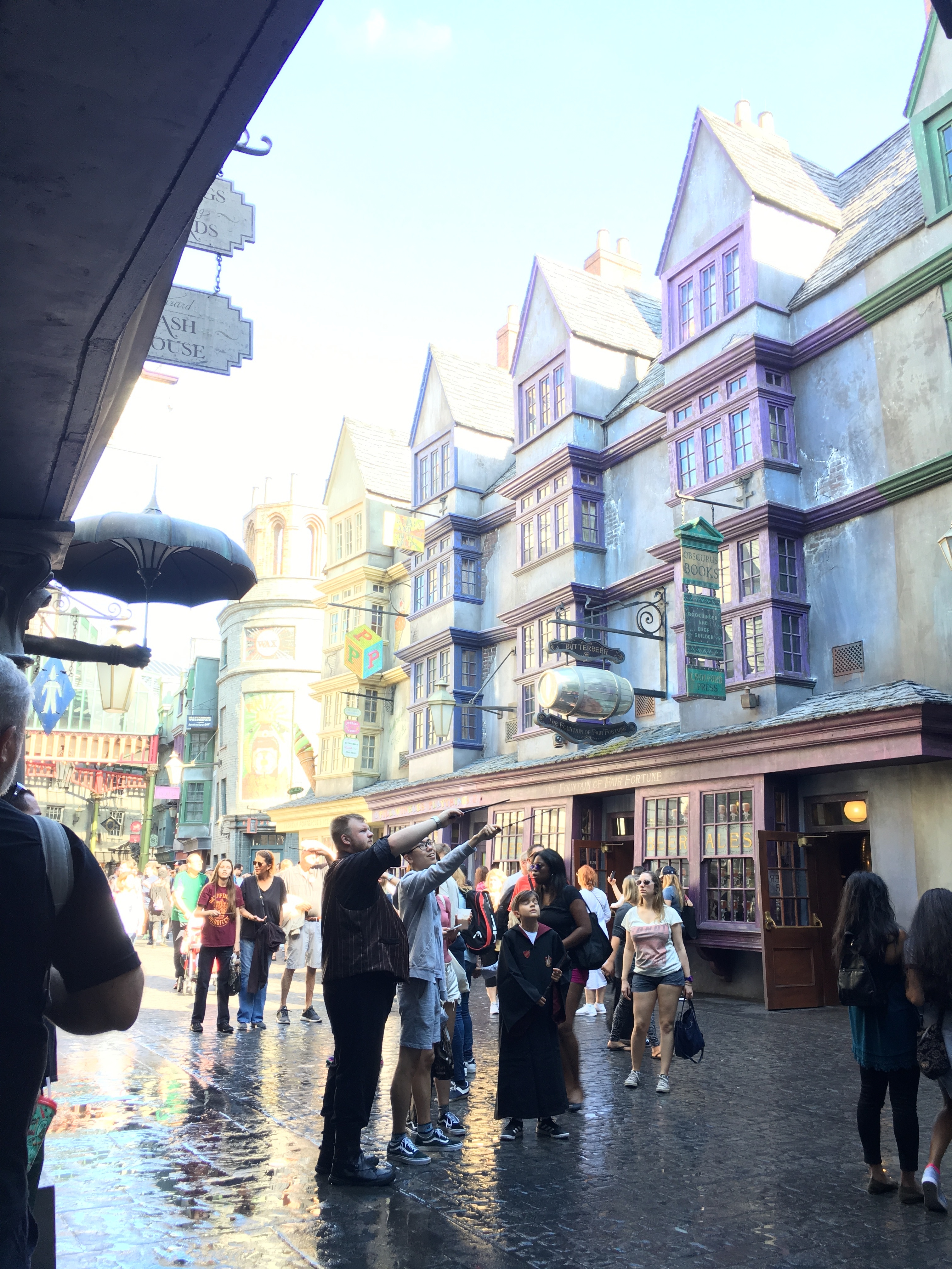 some people casting spells in Diagon Alley at Universal Studios