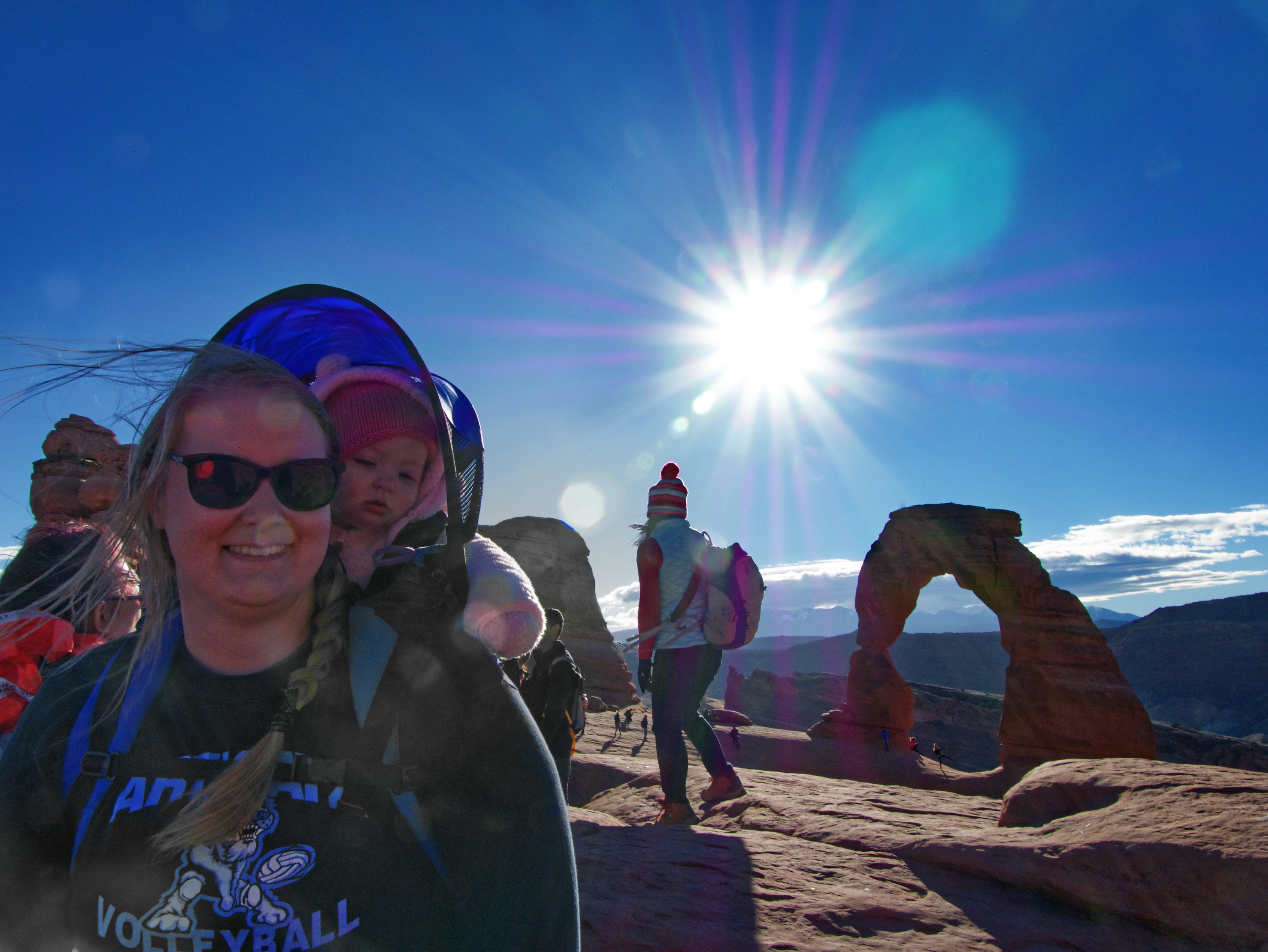 Meagan and Baby in the wind at Delicate Arch