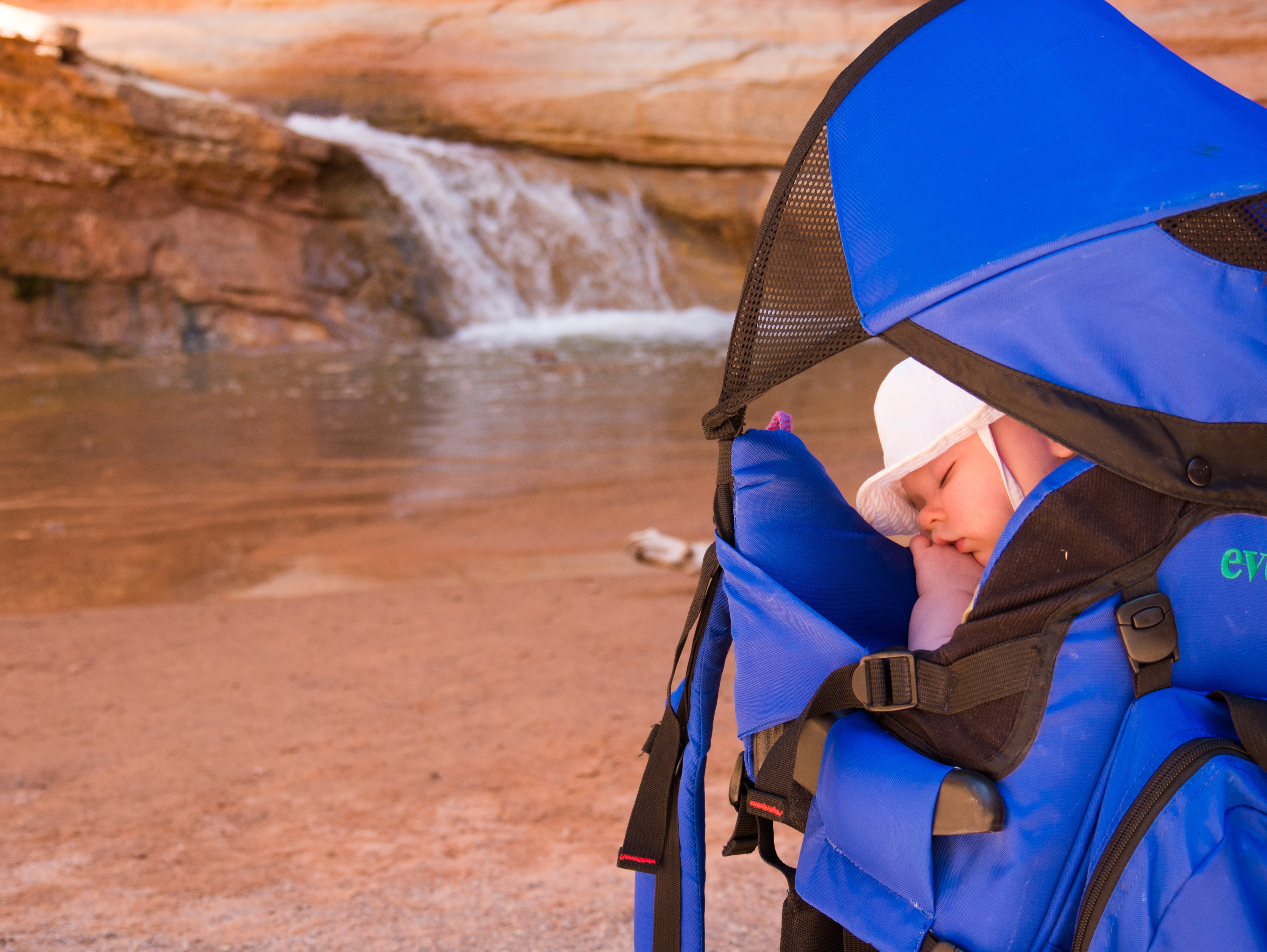 Baby sleeping by waterfall at capitol reef