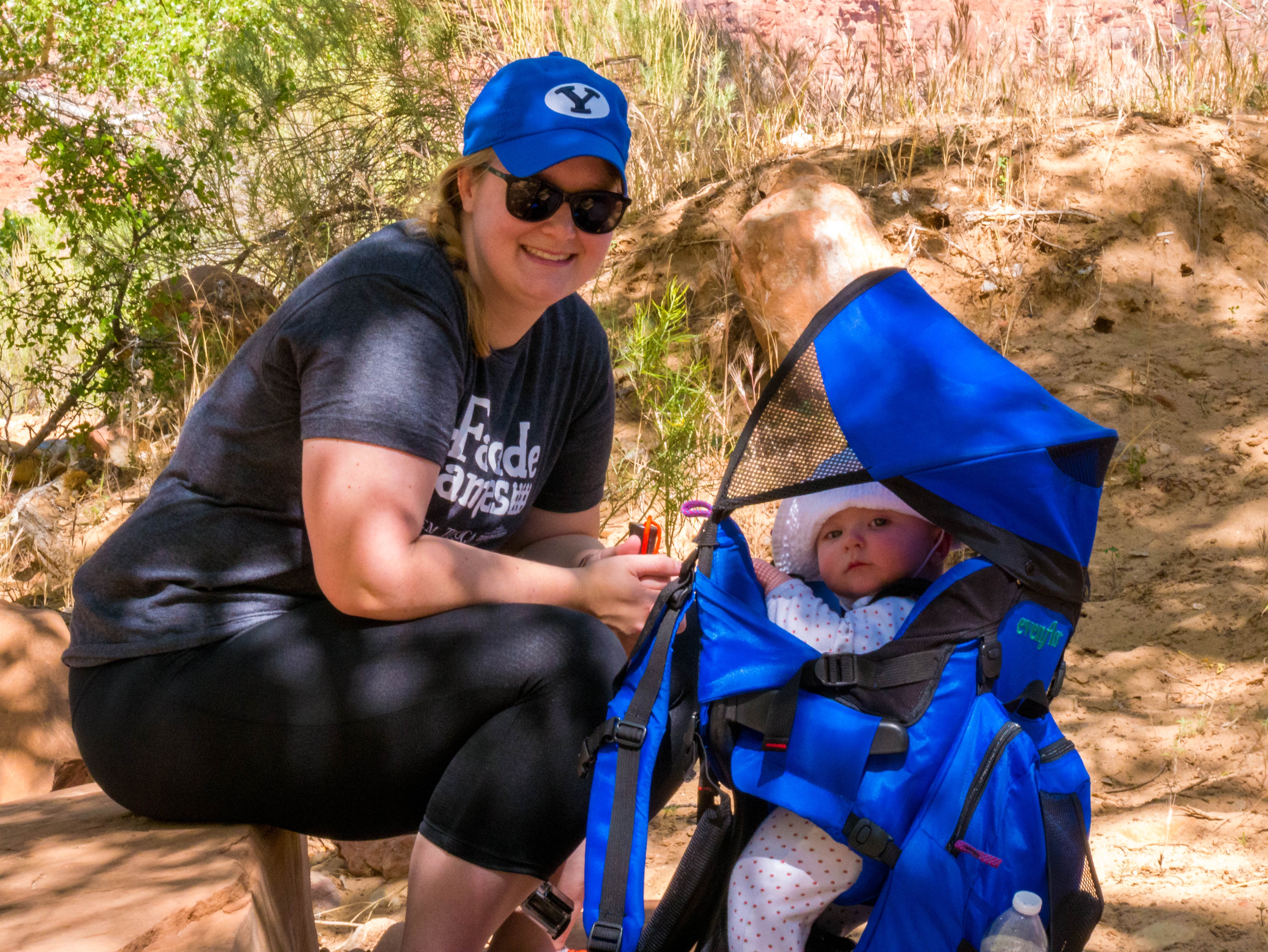 Meagan and baby resting on a hike at zion
