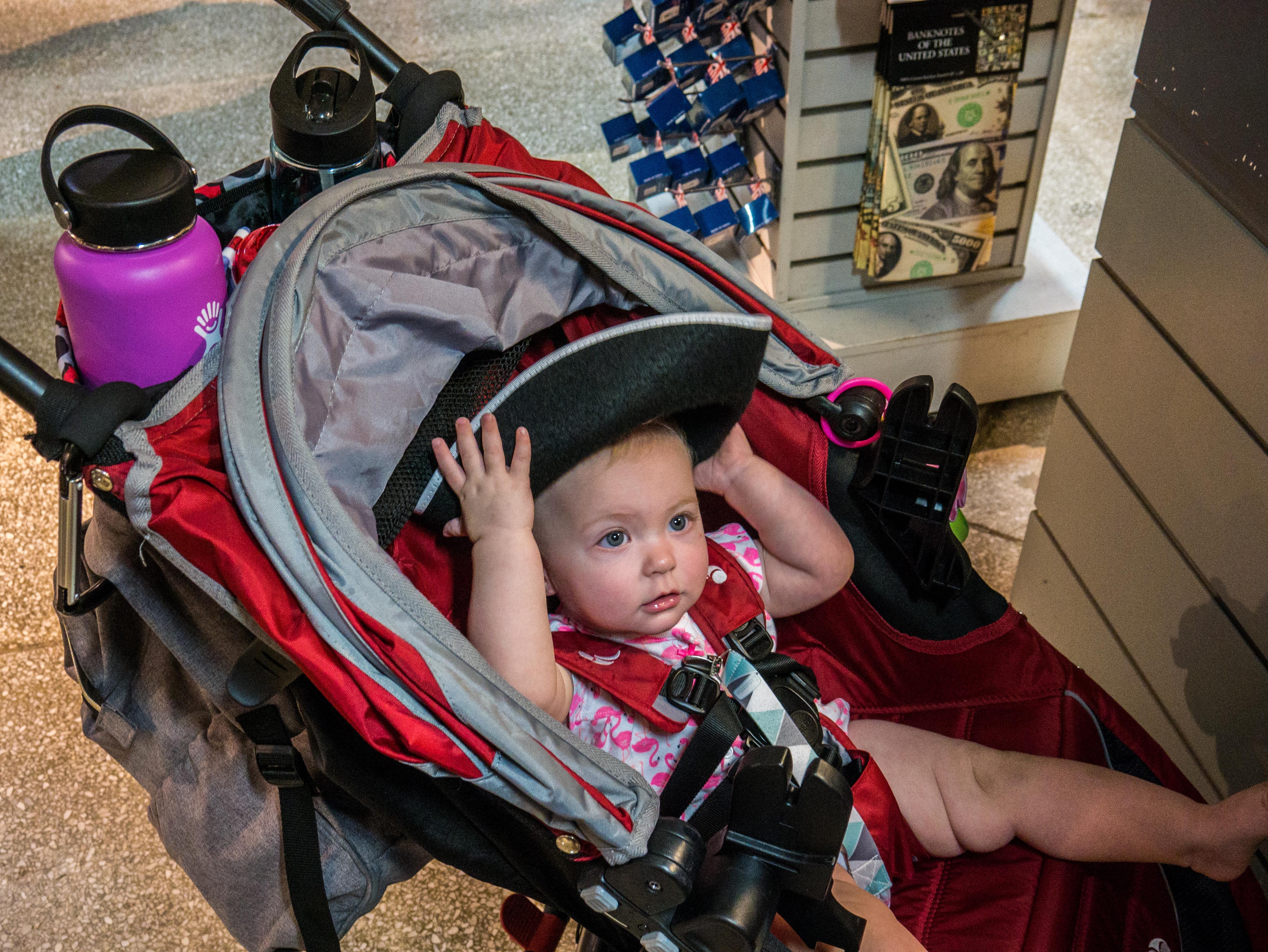 Baby in a stroller at Faneuil Hall wearing a three corner hat