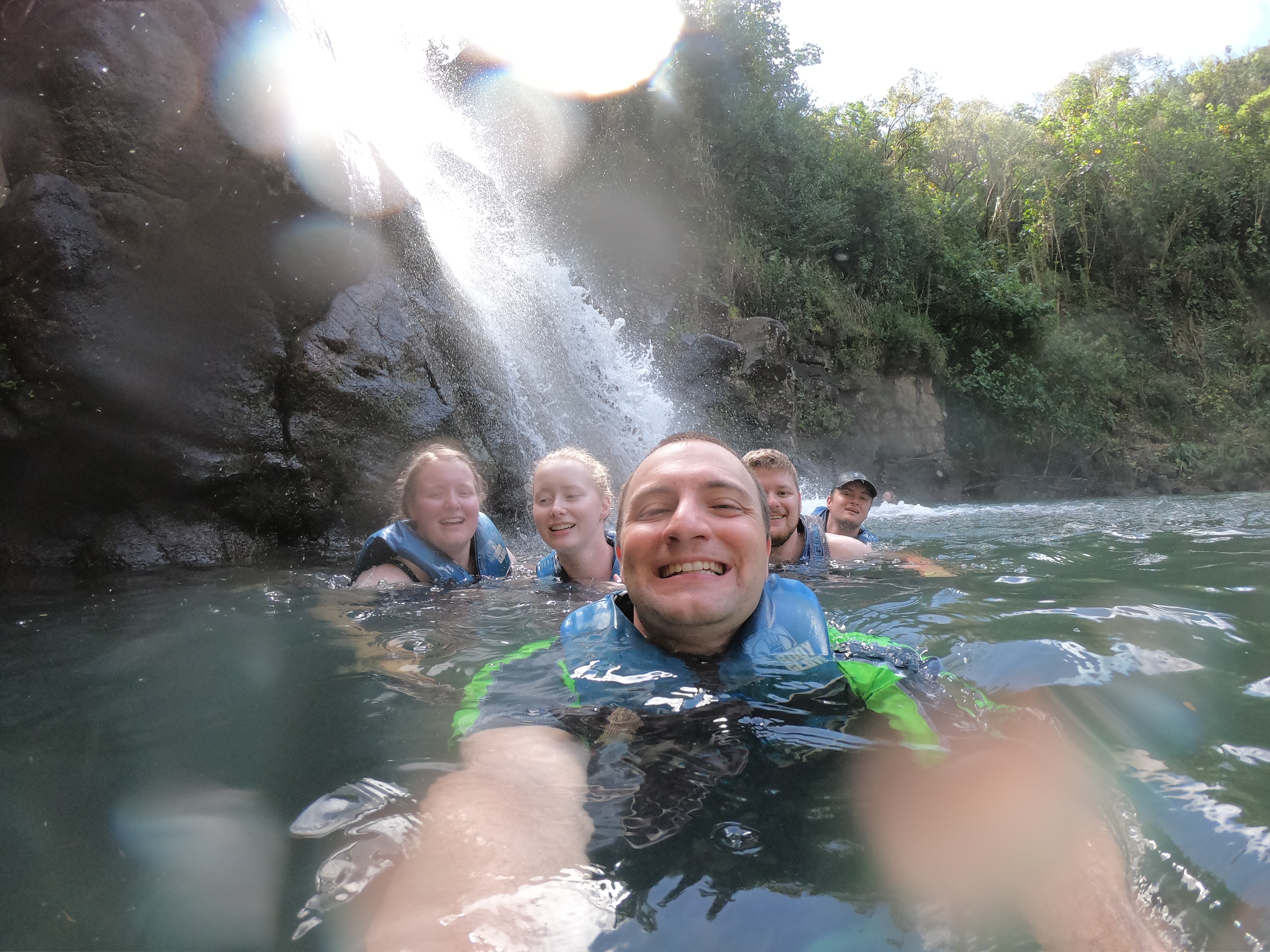 The group swimming in Waimea Falls