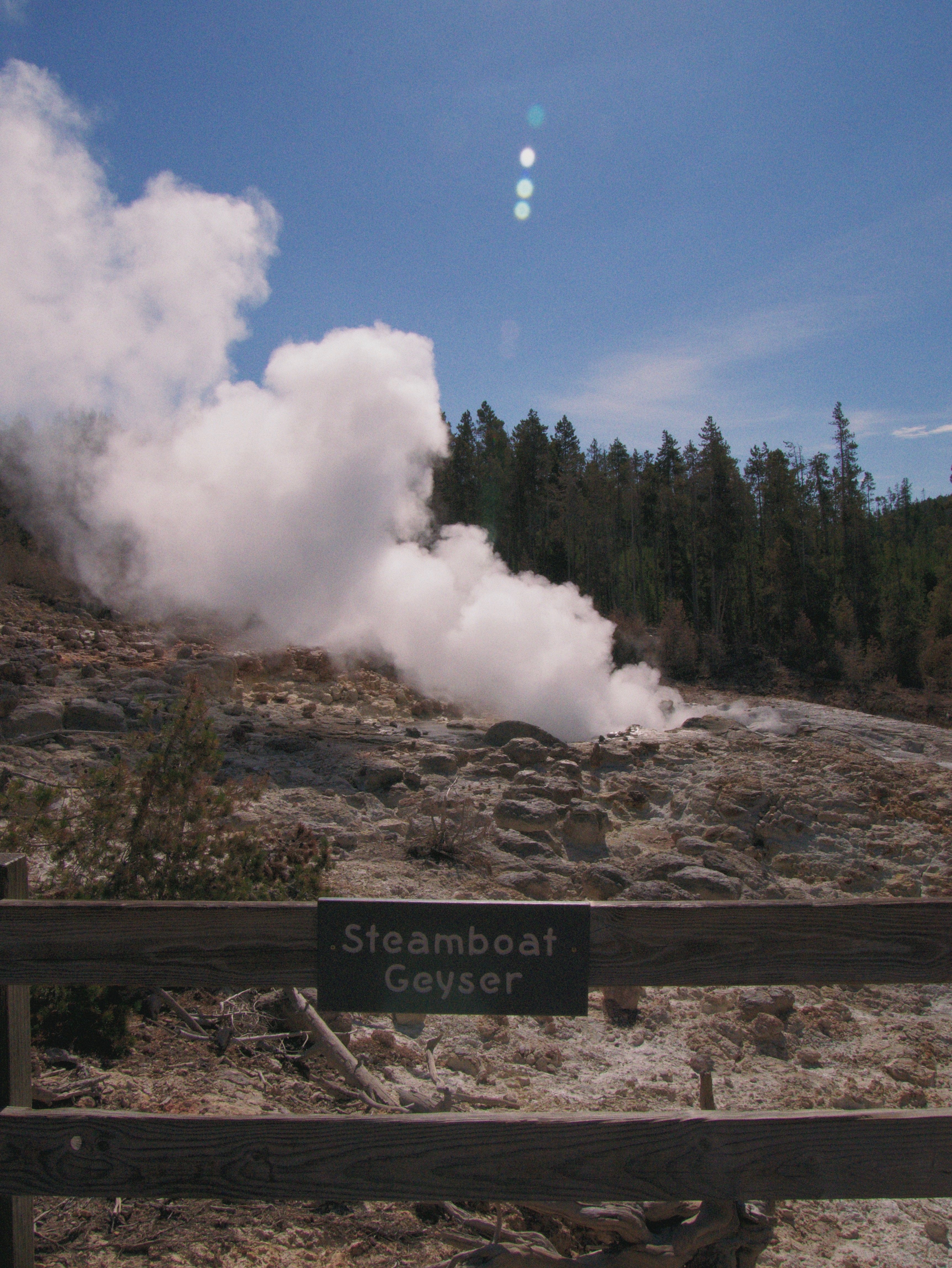 Steamboat geyser with a lot of steam from the upper point