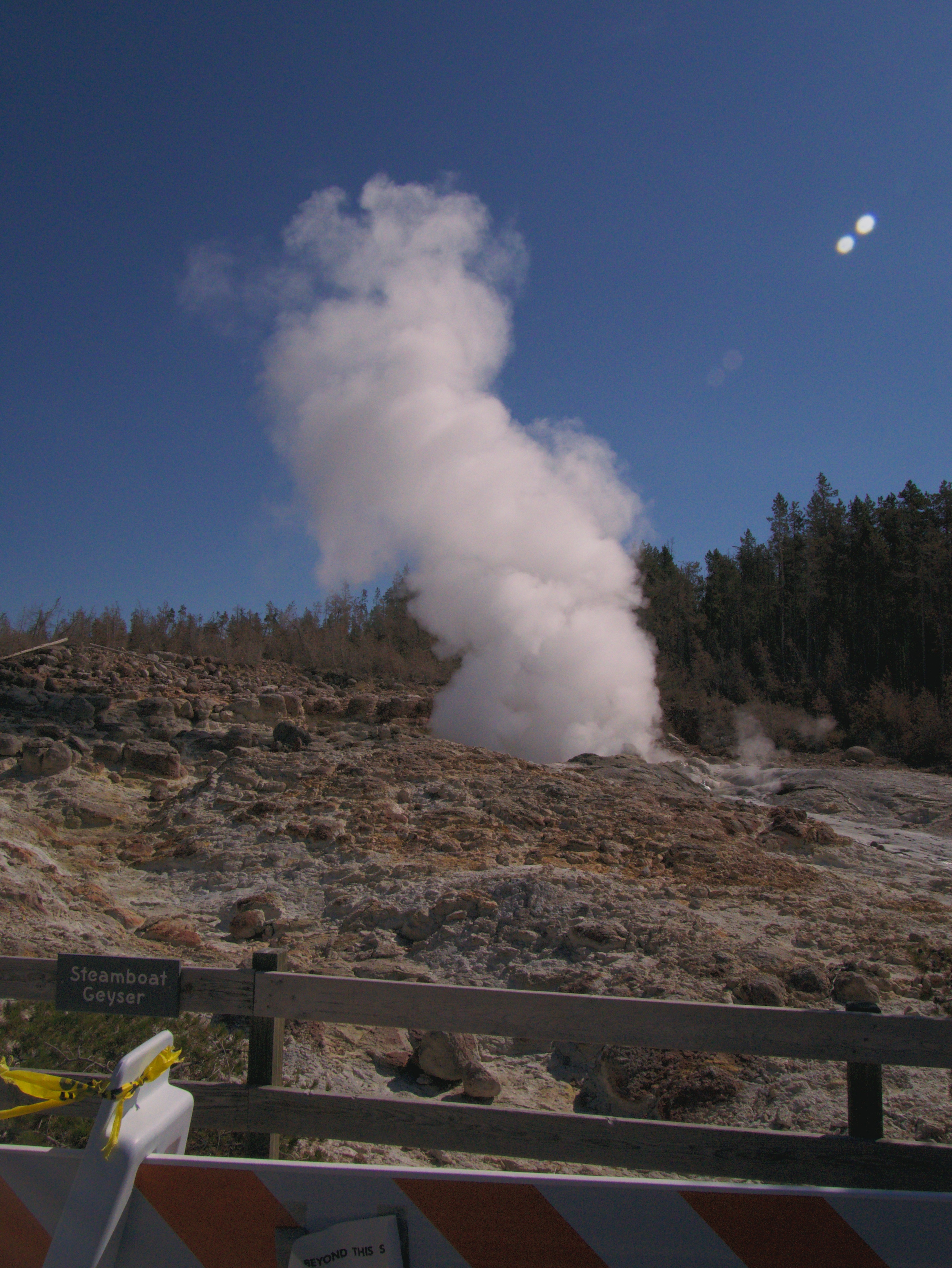 Steamboat geyser with a lot of steam from the lower point