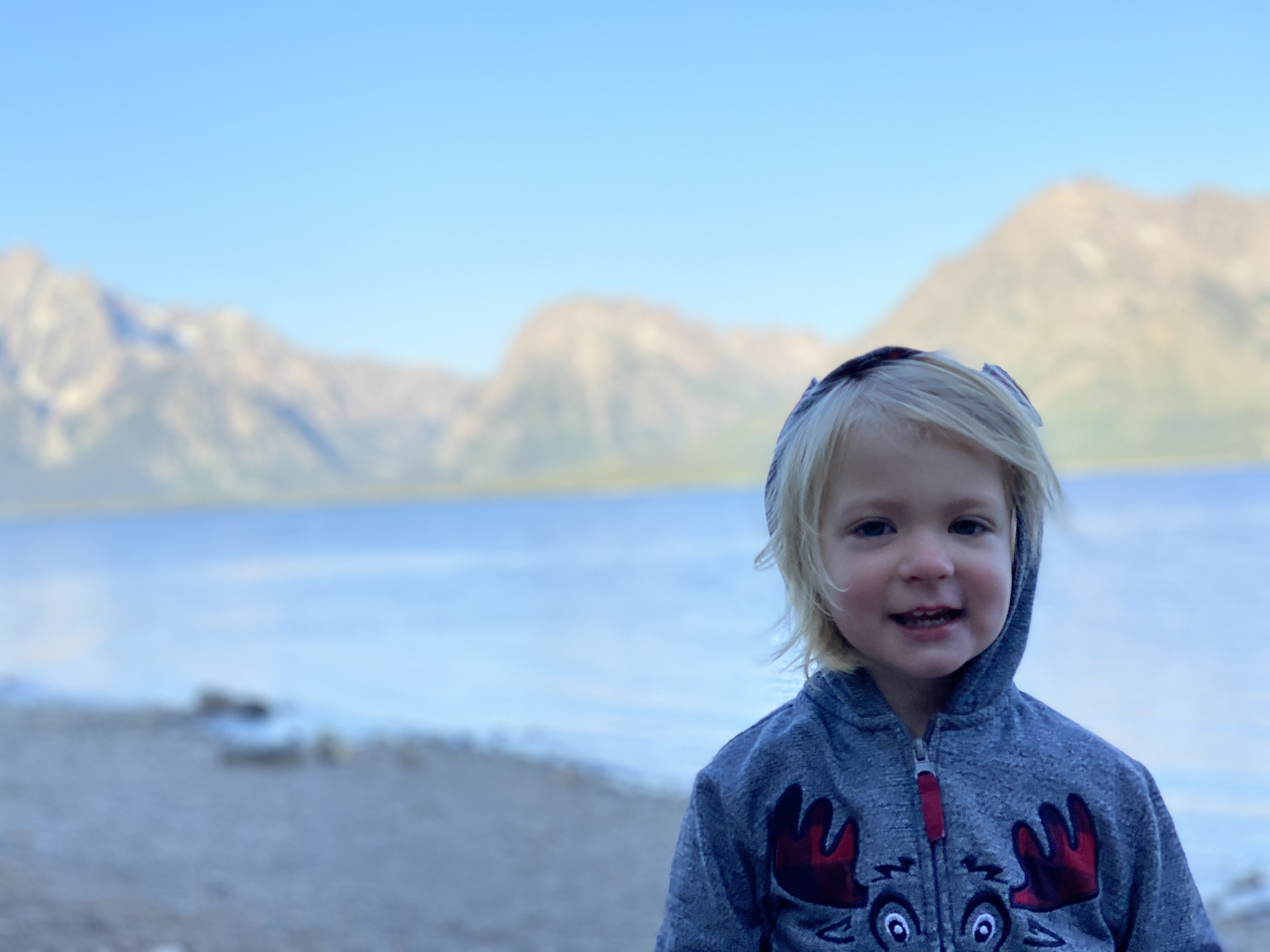 Little girl at Jackson Lake in the early morning at Grand Teton National Park