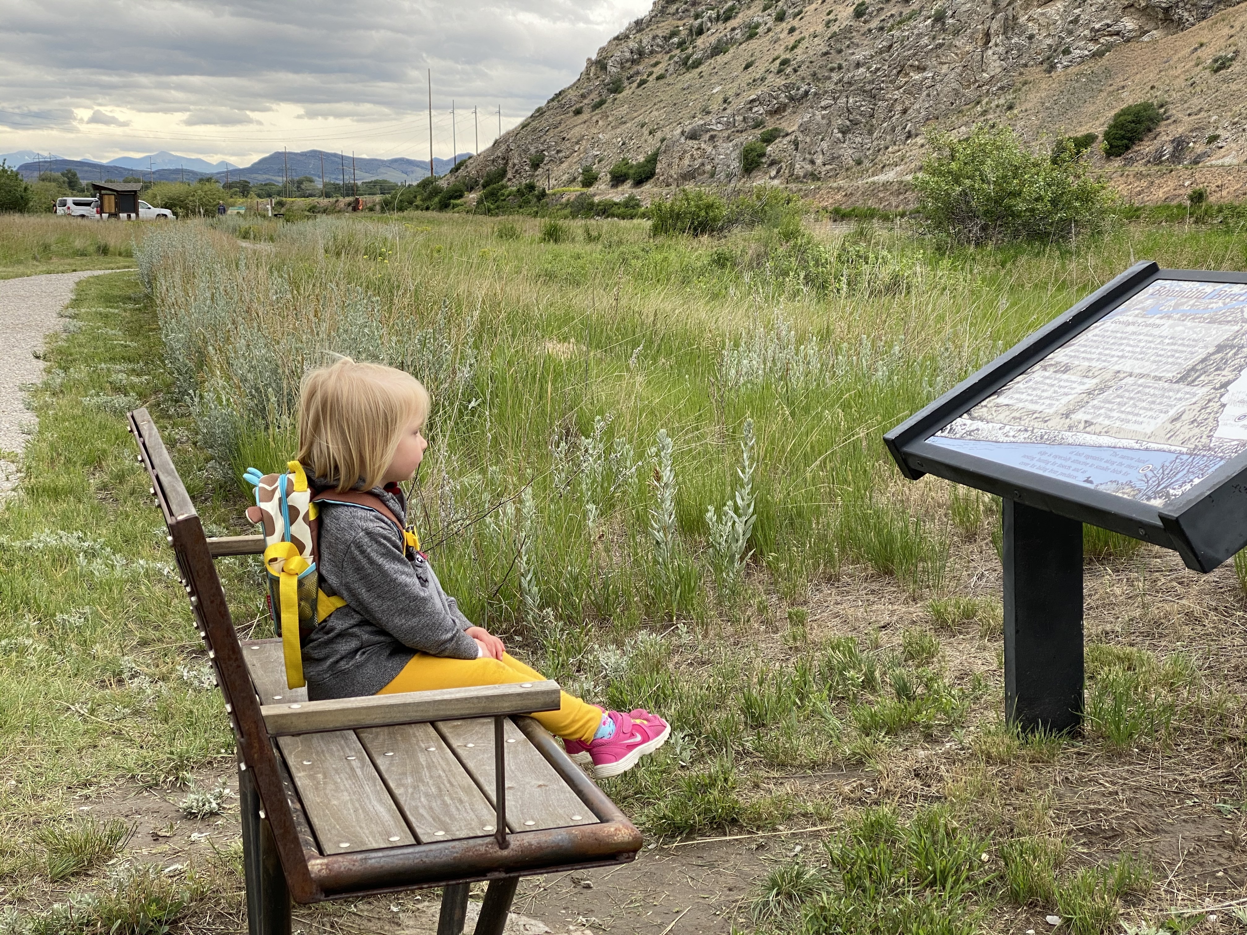 Little girl sitting on a bench at Missouri Headwaters State Park